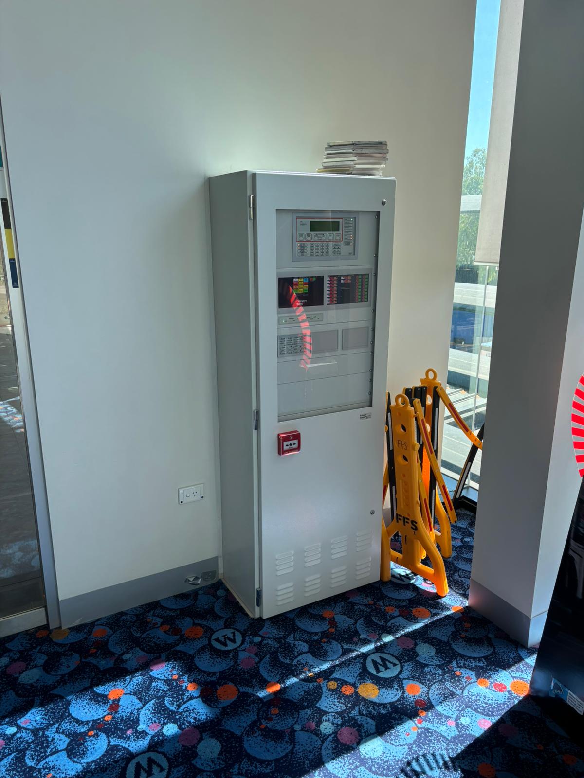 Fire detection panel installed at commercial premises with FFS branding
