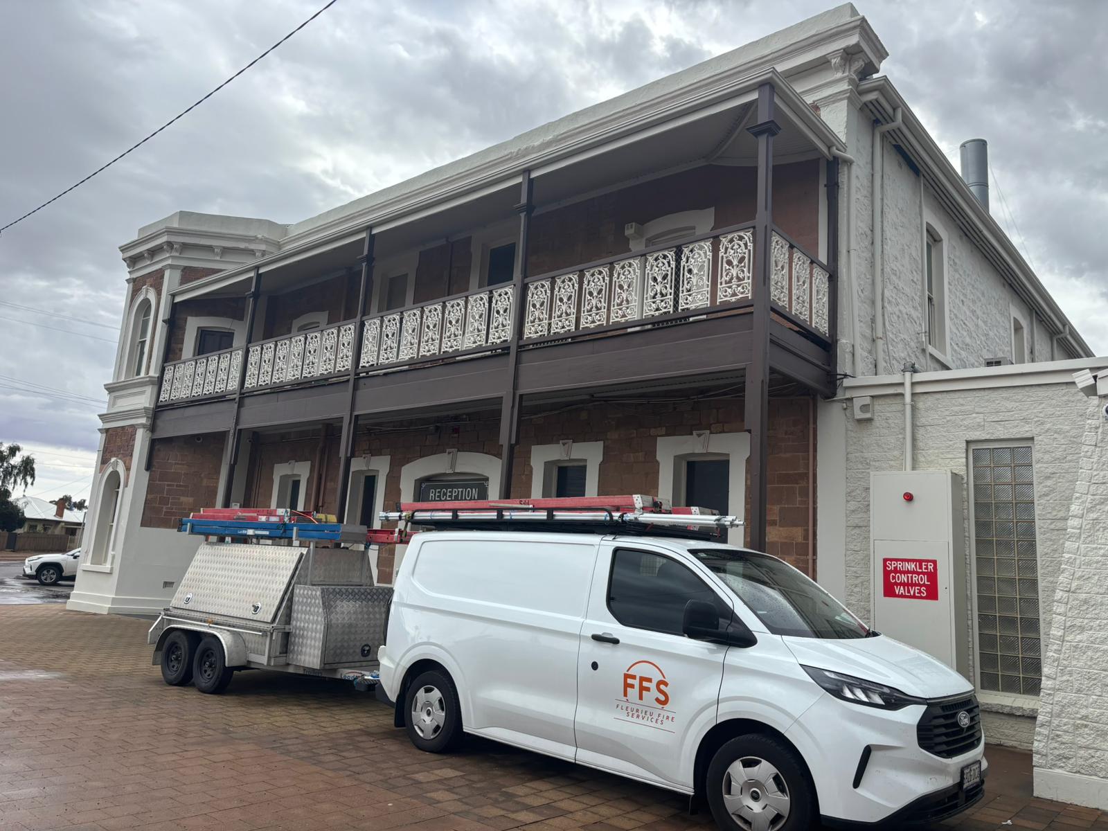 FFS service van and trailer outside a heritage reception building — regional SA sprinkler installation