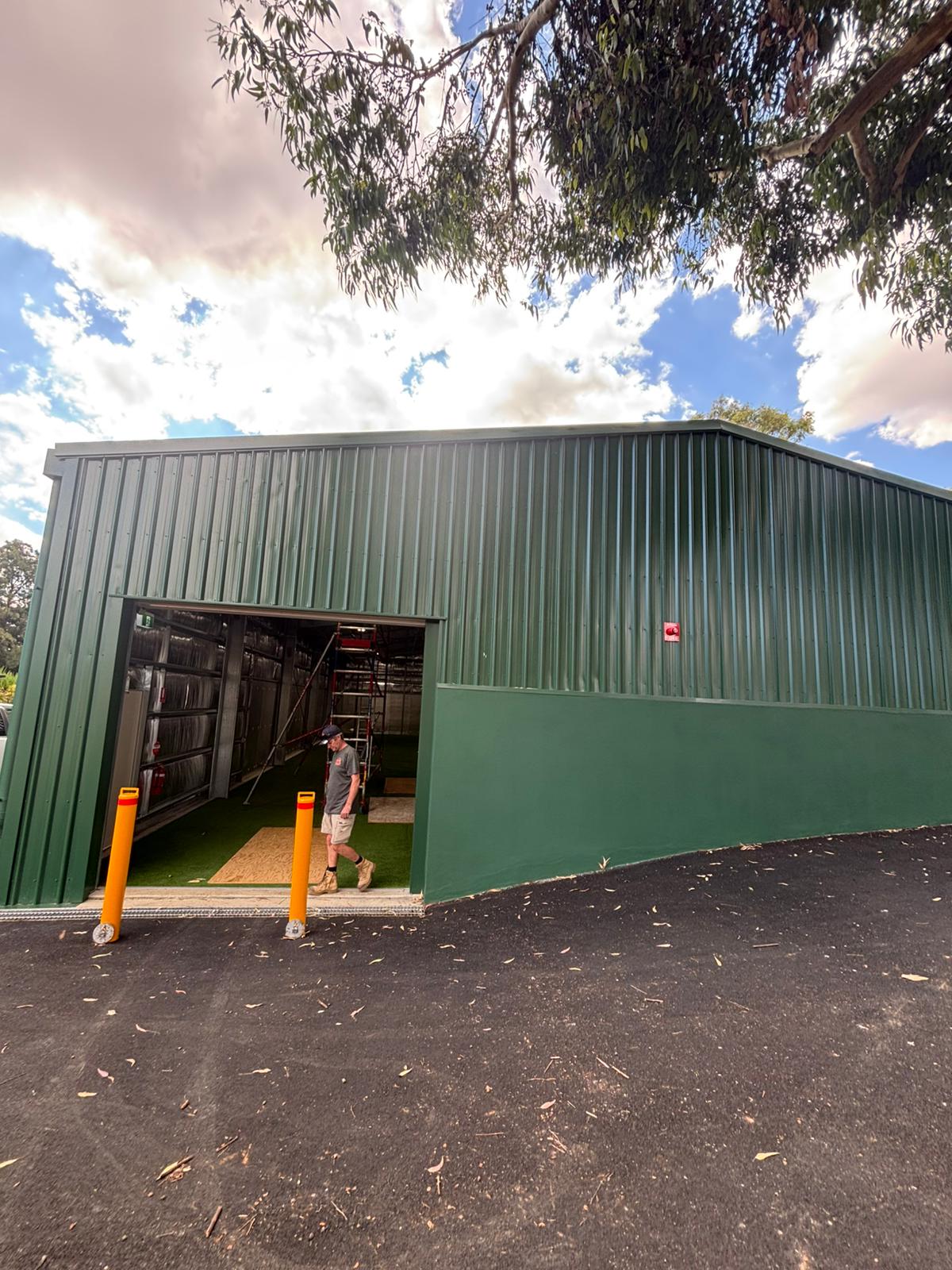 FFS technician at sports facility warehouse being fitted out with fire protection systems